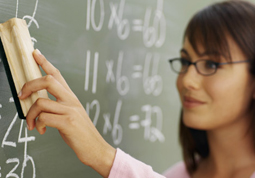 Close-up of teacher cleaning chalkboard with duster